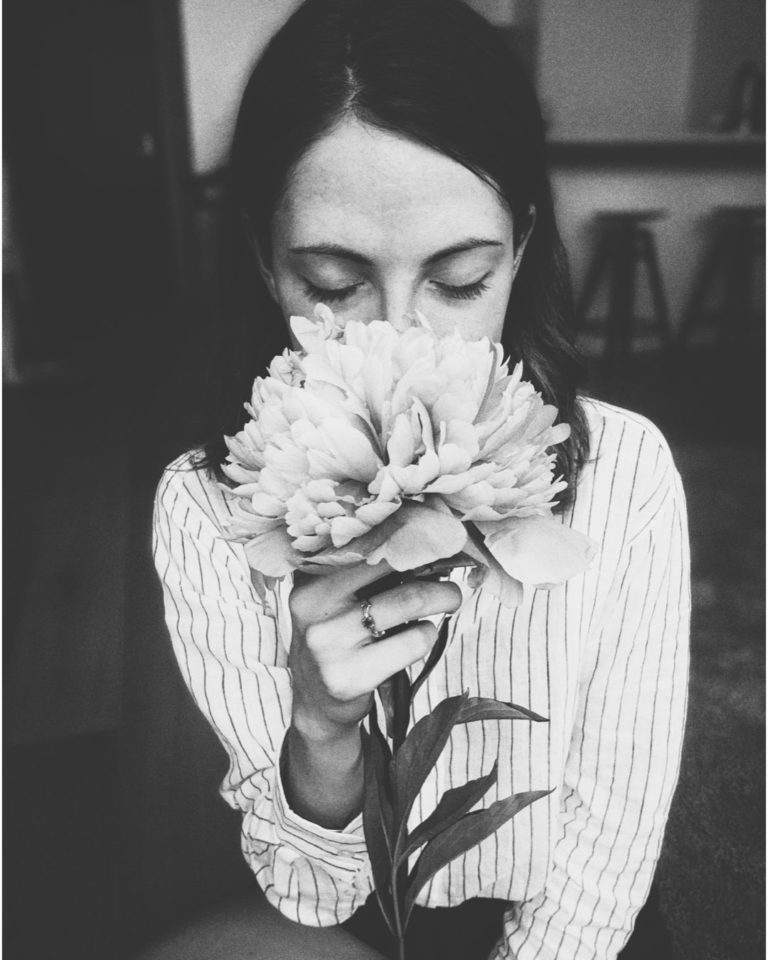 Marketing emocional - mujer oliendo una flor